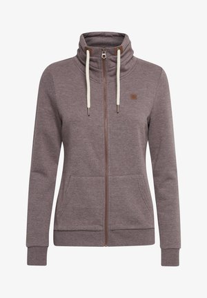 Grå hettegensers med glidelås laget av mykt materiale, med høy krage, to frontlommer, kremfargede snorer og et lite brunt logo-patch.