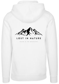 White hoodie featuring a black mountain graphic with the text "LOST IN NATURE" and "found in the mountains" below. Soft texture, standard fit.