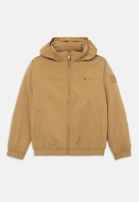 Lys brunt hættejakke med lynlås foran, elastiske manchetter, to sidelommer og lille logo på brystet og venstre ærme.
