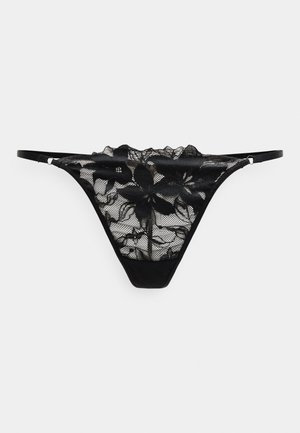Tanga negro de encaje con motivos florales y finas tiras laterales ajustables sobre un fondo blanco.