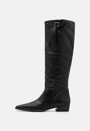 Knee-high black leather boots with a pointed toe, flat heel, and side buckle detail; smooth texture and sleek design.