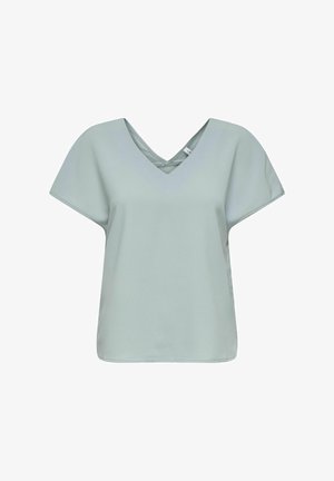 Haut vert menthe à col en V avec des manches courtes et larges, et une coupe décontractée. Texture lisse et design minimaliste. Pas de motifs ni de détails métalliques.