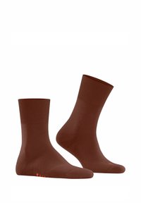 Chaussettes en coton marron avec un bord côtelé, une texture lisse et un logo orange sur la semelle. Conception longueur cheville, idéale pour un usage décontracté.