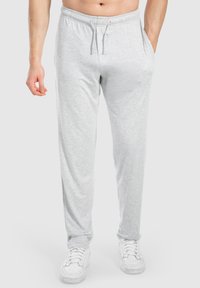 Hellgraue Jogginghosen aus einem weichen Baumwollmix, mit einem elastischen Bund mit Kordelzug, Seitentaschen und einer lockeren Passform.
