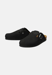 Black clogs made from suede material with a smooth surface, featuring a side buckle and subtle stitching details on the upper.