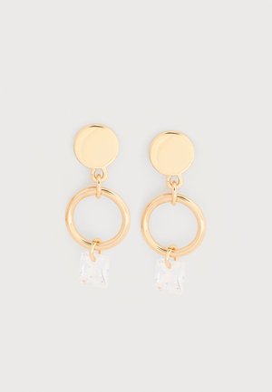 Σκουλαρίκια σε χρυσό τόνο με κυκλικό καρφί, ένα μεγαλύτερο ανοιχτό δαχτυλίδι και έναν μικρό διάφανο τετράγωνο κρύσταλλο που κρέμεται από κάθε δαχτυλίδι.