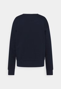 Sudadera azul marino, hecha de tela suave, presenta un cuello redondo, mangas largas, puños acanalados y un corte relajado. Diseño liso, sin patrones.