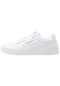 Zapatillas deportivas blancas con parte superior de cuero texturizado, detalles perforados, suela gruesa y una sutil marca en el costado y el talón.