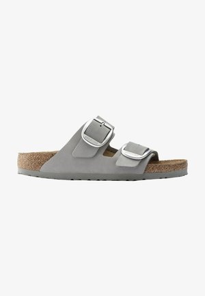 Gray two-strap sandal with adjustable silver-tone metal buckles, soft suede upper, and a cork footbed, featuring a textured rubber sole.