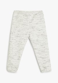 Pantalones de chándal grises hechos de una tela suave y elástica, con un patrón jaspeado y cintura elástica para mayor comodidad. Puños ajustados en los tobillos.