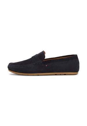 Dark navy suede loafer with moccasin stitching, a rubber sole, and a small tricolor logo accent on the side. Classic slip-on design.
