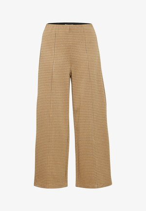 Pantalons larges beige avec un motif à carreaux, présentant une taille haute et un tissu souple pour le confort.