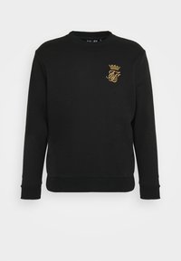 Sudadera negra con cuello redondo, puños y dobladillo de punto acanalado. Presenta un logo bordado en dorado en el lado izquierdo del pecho. Textura suave.