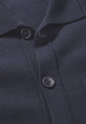 Marineblaues gestricktes Polohemd mit glatter Textur, ausgestattet mit einem Kragen und zwei schwarzen Knöpfen auf der Vorderseite.