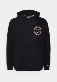 Svart hoodie med en framficka, prydd med en cirkulär logotyp broderad med "Tommy Jeans NYC" i guld. Mjuk, texturerad tyg.