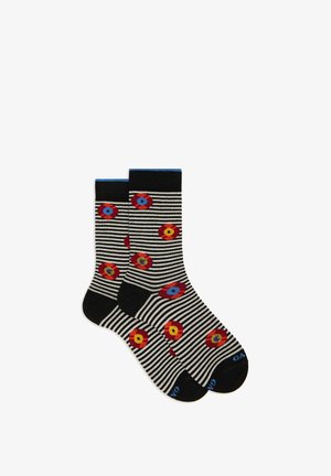 Black and white striped socks featuring red and yellow floral patterns, with blue accents at the cuff and branding on the sole.