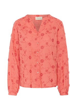Coral blouse with long sleeves, V-neck, and button front. Features floral embroidery and textured fabric with small raised accents.