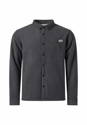 Chemise en velours côtelé gris foncé à manches longues avec des boutons noirs, une poche poitrine sur le côté gauche et une petite étiquette rectangulaire au-dessus de la poche.