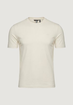 Maglietta a maniche corte color crema con scollo rotondo, piccolo logo sul petto a sinistra e etichetta nera all'interno del colletto.