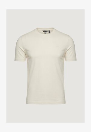 Maglietta a maniche corte color crema con scollo rotondo, piccolo logo sul petto a sinistra e etichetta nera all'interno del colletto.