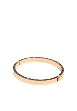 Złota bransoletka z czarną emalią cienko wtopioną oraz wygrawerowanymi literami wokół zewnętrznego brzegu, pokazana na białym tle.