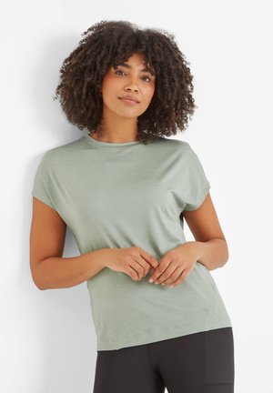 Light green short-sleeve top with a round neckline and a relaxed fit, made of soft fabric, paired with black leggings.