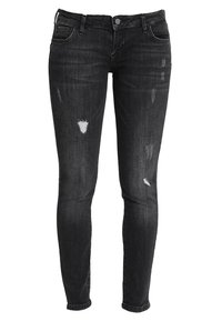 Vaqueros skinny negros hechos de denim, con parches desgastados y un acabado descolorido, con un diseño clásico de cinco bolsillos y cierre de botón.