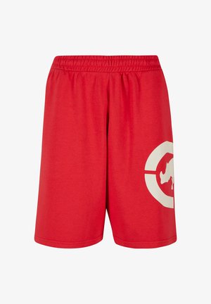 Shorts rouges en coton avec une taille élastique, présentant un grand design graphique blanc sur la jambe gauche et une texture lisse.