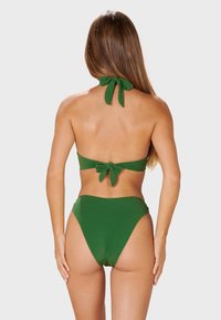 Green bikini set featuring a halter neck top tied at the back and high-waisted bottoms. Fabric appears smooth with slight sheen.