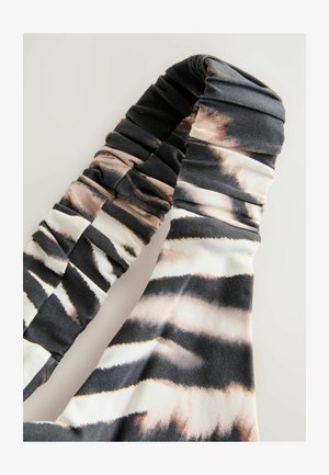 Ruched fabric strap in black, white, and beige with a striped pattern. Smooth texture with varying widths and tight gathers along the length.
