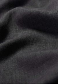 Zwart stof met een gladde, zachte textuur. Het materiaal lijkt lichtgewicht en heeft een subtiele glans, met fijne, constante weefpatronen.