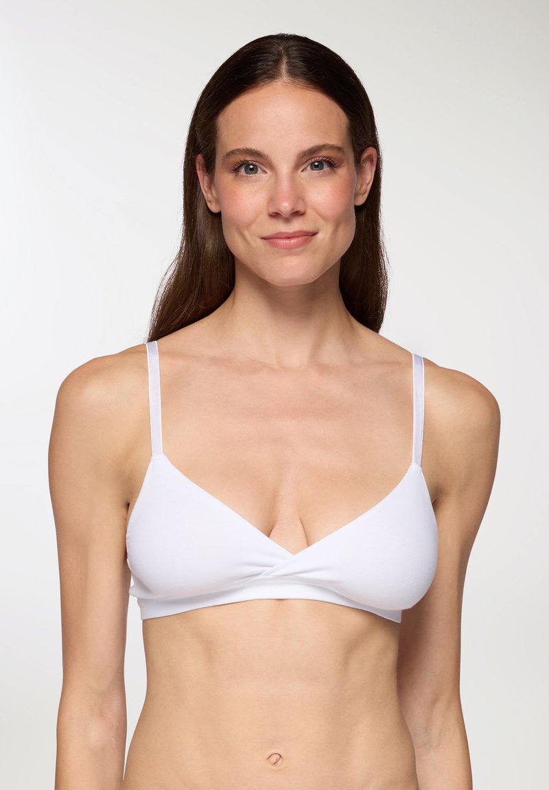 Bralette bianco con spalline sottili, caratterizzato da un design frontale attorcigliato. Texture liscia e stile minimalista, adatto per l'uso quotidiano.