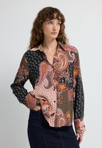 Long-sleeve shirt featuring a colorful paisley pattern with black, pink, and orange sections, made of lightweight fabric, button-up design.