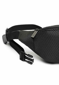 Black mesh fanny pack with a curved shape, featuring a zippered pocket and adjustable strap, highlighted by a plastic buckle and subtle branding.