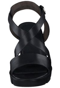 Svarta lädersandaler med korsade remmar, öppen tå och plattformsåle. Har en spänne stängning och en slät yta.