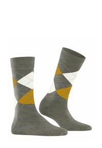 Calzini argyle grigi con motivi a rombi bianchi, gialli e blu, presentati con un calzino leggermente inclinato per una migliore visibilità.