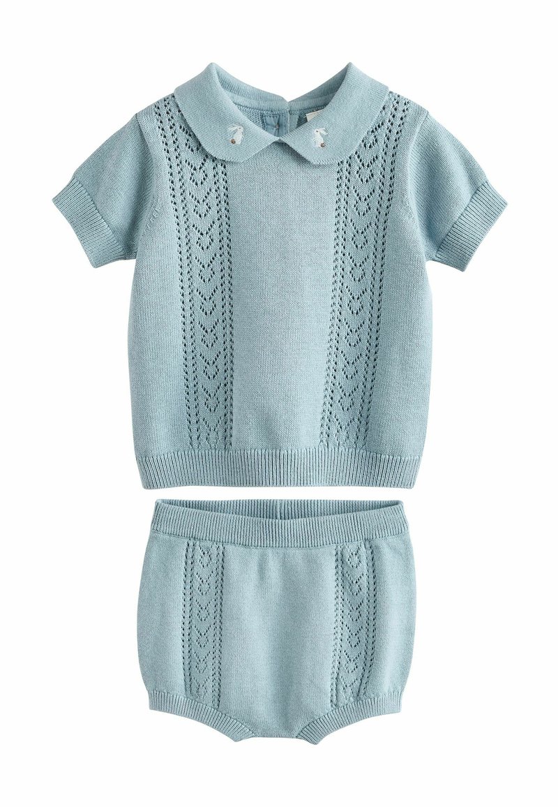 Ensemble tricoté bleu clair comprenant un haut à manches courtes avec col et détails à motifs, associé à un short assorti.
