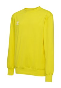 Gul crew neck sweatshirt i mjukt tyg. Har långa ärmar, ribbade mudd och en liten vit logotyp på vänster bröst.