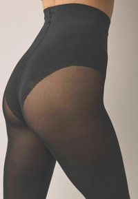 Schwarze, hoch taillierte Strumpfhose mit einem transparenten unteren Bereich, glatter Textur und nahtlosem Bunddesign, das eine eng anliegende Optik erzeugt.