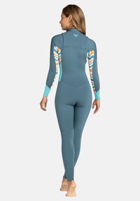 Wetsuit in slate blue with patterned accents in orange and white. Long sleeves, full length, smooth texture, with back zipper detail.