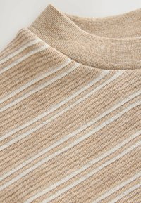 Beige knitted sweater featuring horizontal white stripes, a rounded neckline, and a textured fabric with ribbed details.