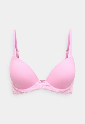 Rožinė pagalvėlėmis išklota liemenėlė su lygiais puodeliais ir delikatine nėriniuota juosta apačioje. Reguliuojamos petnešos pritaikymui. Paprastas, apvalus dekoro dizainas.