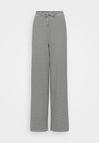 Black and white striped wide-leg pants with a drawstring waistband. Soft fabric with a loose fit and vertical stripe pattern.
