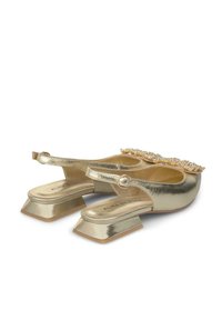 Goldene, metallische Slingback-Schuhe mit einem quadratischen Blockabsatz, die eine mit Perlen besetzte Akzentuierung an der Zehe und einen Riemen mit einer runden Schnalle aufweisen.
