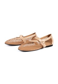 Beige mesh flats with a smooth leather toe and heel. Features a rounded shape, a strap with a circular buckle, and a flexible black sole.