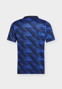 Short-sleeve navy blue and bright blue polo shirt with diagonal stripe and geometric pattern, shown from the back.