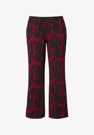 Mustat housut, joissa on punainen abstrakti kuvio, jossa on kevyitä raitoja, leveät lahkeet ja joustava vyötärömato mukavuutta varten.