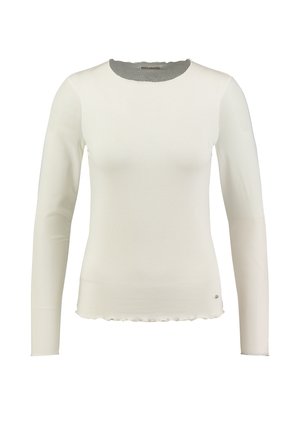 Biała bluzka z długim rękawem, wykonana z fakturowanej tkaniny, z falbaniastym dołem i okrągłym dekoltem. Posiada mały akcent logo na dole.