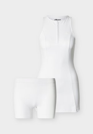 Λευκό αμάνικο φόρεμα τένις με φερμουάρ στο μπροστινό μέρος και ταιριαστό λευκό σορτς, παρουσιασμένα σε απλό ανοιχτό υπόβαθρο.