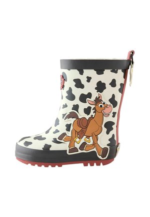 Child's rain boot with black and white cow spots and a smiling cartoon horse wearing a saddle on the side.